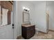 Well-lit bathroom featuring a granite countertop, vanity with dark wood cabinets, and a glass door shower at 122 N Longfellow Ln, Mooresville, NC 28117