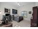 Bedroom features a dark wood dresser, a window with a view, and dark walls at 122 N Longfellow Ln, Mooresville, NC 28117