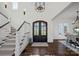 Spacious foyer featuring a staircase, dark hardwood floors, and a grand entrance with double doors at 122 N Longfellow Ln, Mooresville, NC 28117
