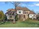 Beautiful two-story home with manicured landscaping, a stone and siding facade, and a manicured lawn at 122 N Longfellow Ln, Mooresville, NC 28117