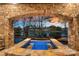 Stunning lake view framed by stone archway above a modern hot tub at 122 N Longfellow Ln, Mooresville, NC 28117