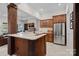 Kitchen featuring a center island, stainless steel appliances, and an open view into the living room at 122 N Longfellow Ln, Mooresville, NC 28117