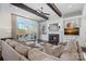 Cozy living room with a fireplace, built-in shelves, dark hardwood floors, and lake views at 122 N Longfellow Ln, Mooresville, NC 28117