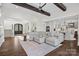 Expansive living room with dark hardwood floors, a large sofa, and an open floor plan at 122 N Longfellow Ln, Mooresville, NC 28117