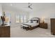 A bright main bedroom features neutral colors, a ceiling fan, and large windows at 122 N Longfellow Ln, Mooresville, NC 28117