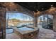 Stone hot tub under a covered patio with lake views and a spiral staircase at 122 N Longfellow Ln, Mooresville, NC 28117