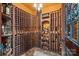 Wine cellar with wooden racks filled with bottles of wine and liquor and a stone floor at 122 N Longfellow Ln, Mooresville, NC 28117