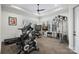 Bright workout room featuring a tray ceiling, ceiling fan, and an array of fitness machines at 122 N Longfellow Ln, Mooresville, NC 28117