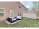 Cozy backyard patio with stylish seating, a small grassy area, and a privacy fence; perfect for outdoor relaxation at 137 Woodbridge Cir, Mount Holly, NC 28120