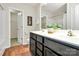 Bright bathroom with a double sink vanity, modern fixtures, and a walk-in closet for ample storage at 137 Woodbridge Cir, Mount Holly, NC 28120
