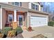 Charming two-story townhouse featuring brick accents, attached garage, and attractive landscaping at 137 Woodbridge Cir, Mount Holly, NC 28120