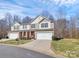 Attractive two-story townhouse featuring an attached two-car garage and well-manicured landscaping at 137 Woodbridge Cir, Mount Holly, NC 28120