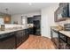 Modern kitchen featuring dark cabinetry, laminate countertops, and stainless steel appliances at 137 Woodbridge Cir, Mount Holly, NC 28120