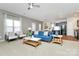 Open-concept living room with a view of the kitchen, modern furnishings, and ample natural light at 137 Woodbridge Cir, Mount Holly, NC 28120