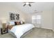 Serene bedroom with vaulted ceilings, a ceiling fan, natural light, and neutral décor provides a calming retreat at 137 Woodbridge Cir, Mount Holly, NC 28120