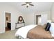 Spacious bedroom with a ceiling fan, decorative mirror, and convenient access to the bathroom and hallway at 137 Woodbridge Cir, Mount Holly, NC 28120