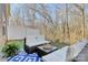 Inviting outdoor patio with comfortable seating, a glass-topped table, and a view of the surrounding trees at 137 Woodbridge Cir, Mount Holly, NC 28120