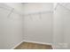 Spacious walk-in closet features wire shelving and neutral carpeting at 137 Woodbridge Cir, Mount Holly, NC 28120