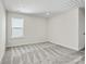 Neutral bedroom featuring plush carpet, ample natural light, and a closet at 13705 Roderick Dr # 194, Huntersville, NC 28078