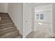 Hallway with stairs and doorway to a room with windows at 13705 Roderick Dr # 194, Huntersville, NC 28078