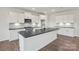 Modern kitchen features white cabinets, a dark countertop island, and stainless steel appliances at 13705 Roderick Dr # 194, Huntersville, NC 28078
