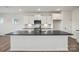Well-lit kitchen boasts white cabinetry, stainless steel appliances, and dark countertops at 13705 Roderick Dr # 194, Huntersville, NC 28078