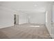 Expansive living room featuring neutral carpet, recessed lighting, and multiple doorways at 13705 Roderick Dr # 194, Huntersville, NC 28078