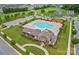 Aerial view of community pool with lounge chairs, playground, and clubhouse amenities at 13705 Roderick Dr # 194, Huntersville, NC 28078