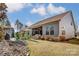 Charming home with outdoor living space featuring a cozy patio, fire pit, and well-maintained backyard at 14827 Batteliere Dr, Charlotte, NC 28278