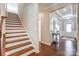 Bright foyer area with wood stairs, and wood flooring at 14827 Batteliere Dr, Charlotte, NC 28278