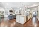 Open kitchen and living room concept with a large kitchen island and hardwood flooring at 14827 Batteliere Dr, Charlotte, NC 28278