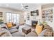 Cozy living room featuring a fireplace, built-in shelving, and comfortable seating, perfect for relaxation at 14827 Batteliere Dr, Charlotte, NC 28278
