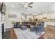 Open-concept living room featuring a large sectional sofa, fireplace, and hardwood floors at 14827 Batteliere Dr, Charlotte, NC 28278