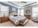 Relaxing main bedroom with a tray ceiling, accent wall, and ample natural light at 14827 Batteliere Dr, Charlotte, NC 28278