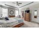 Comfortable bedroom featuring a tray ceiling, plenty of natural light, and a ceiling fan at 14827 Batteliere Dr, Charlotte, NC 28278