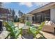 Backyard with brick patio, comfortable chairs, a fire pit, and a lush green lawn at 14827 Batteliere Dr, Charlotte, NC 28278