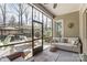 Comfortable screened porch with wicker seating, an outdoor rug and a ceiling fan at 14827 Batteliere Dr, Charlotte, NC 28278