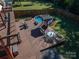 A spacious backyard with a deck, a gazebo, and above ground pool, all surrounded by a wooden fence at 1501 Fern Forest Dr, Gastonia, NC 28054