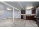 Finished basement with stainless steel appliances, light grey walls, and wood look flooring at 1501 Fern Forest Dr, Gastonia, NC 28054