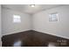 Bedroom with hardwood floors, neutral paint, and windows bringing in natural light at 1501 Fern Forest Dr, Gastonia, NC 28054