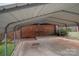 Large carport with concrete foundation, metal roof, and wooden shed at the back at 1501 Fern Forest Dr, Gastonia, NC 28054