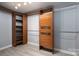This closet features custom wood organizers with drawers and shelves and wood look flooring at 1501 Fern Forest Dr, Gastonia, NC 28054