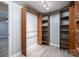 Spacious closet with custom wood organizers, shelves, lighting, and wood look floors at 1501 Fern Forest Dr, Gastonia, NC 28054