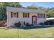 Exterior view of a two-story home with light yellow siding, red shutters, and a green lawn at 1501 Fern Forest Dr, Gastonia, NC 28054
