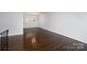 Bright living room with hardwood floors, large window, and neutral color palette at 1501 Fern Forest Dr, Gastonia, NC 28054