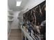 Storage room with custom shelving, a utility sink, and light grey walls at 1501 Fern Forest Dr, Gastonia, NC 28054