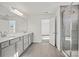 Bright bathroom featuring a double vanity, tiled floor, and enclosed shower with glass door at 15015 Meadows Hunt Ln # 164, Huntersville, NC 28078