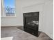 Modern black fireplace with white mantel, next to a window offering a view of the outside at 15015 Meadows Hunt Ln # 164, Huntersville, NC 28078