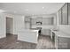 Modern kitchen with stainless steel appliances, white countertops, and sleek gray cabinetry at 15015 Meadows Hunt Ln # 164, Huntersville, NC 28078