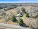 Expansive aerial view of a charming home featuring a long driveway and mature landscaping on a large lot at 1612 Forum Ln, Iron Station, NC 28080